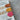 Front-angle view of brown, yellow, and pink leather bookmarks placed inside an open book, showcasing the logo on the bookmarks along with their high-quality, handmade design and functionality in a real-world setting.