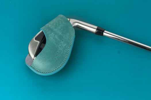 Cyan blue leather magnetic iron head cover on a golf club against a blue background