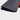 Close-up of a black pebbled leather driver headcover with a dark navy velvet lining and a bright red accent stripe, shown on a light gray background.