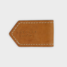 Brown lleather magnetic bookmark with 'LAYOVER and co' engraving on a light gray background